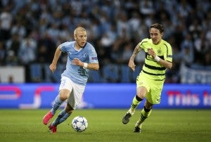 Malmo's Anton Tinnerholm (L) and Celtic's Stefan Johansen vie for the ball during the UEFA Champions League play-off second leg football match between Malmo FF and Celtic FC at Malmo New Stadium, in Malmo, Sweden, on August 25, 2015.  AFP PHOTO /TT NEWS AGENCY /  ANDREAS HILLERGREN   +++ SWEDEN OUT +++